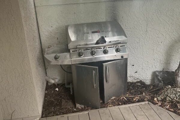 a grill with doors and a grill on the side of a building
