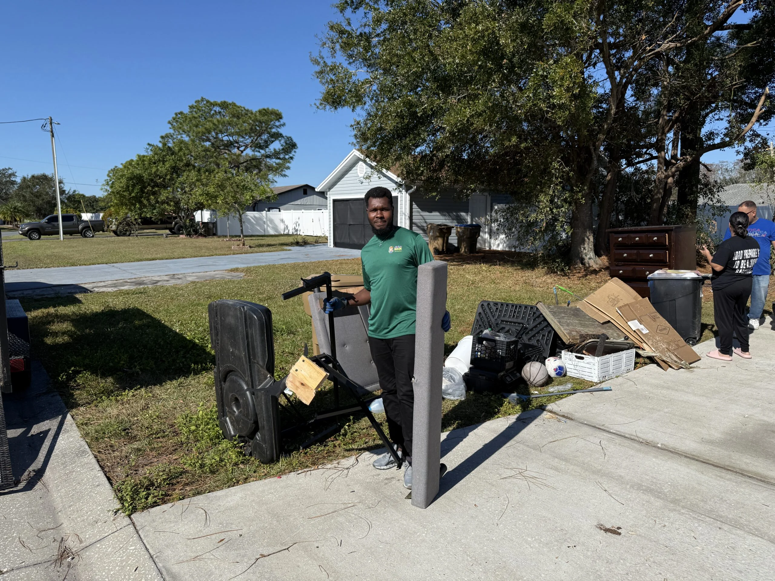 a man standing next to a pile of trash
