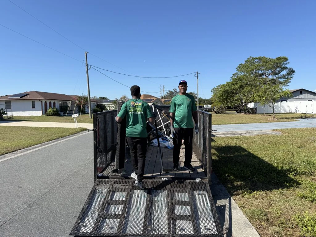 two men standing on a trailer